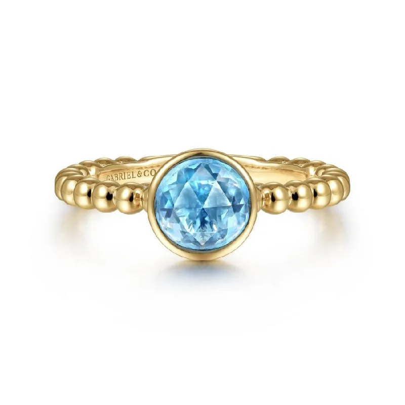 Rings featuring kyanite for rare blue finger beauty -14K Yellow Gold Round Blue Topaz Bezel Set Ring with Bead Shank